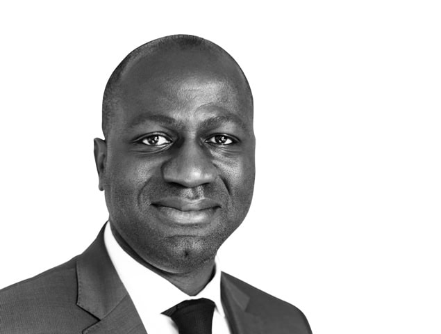 African businessman in formal suit smiling confidently.