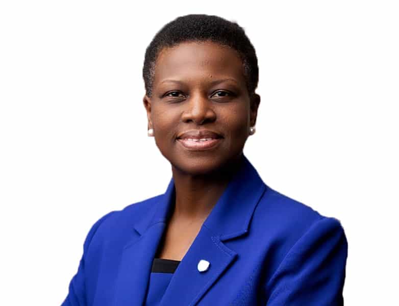Confident African woman in blue suit promoting trade and investment.