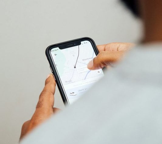 User using a ride-hailing app on smartphone for transportation.