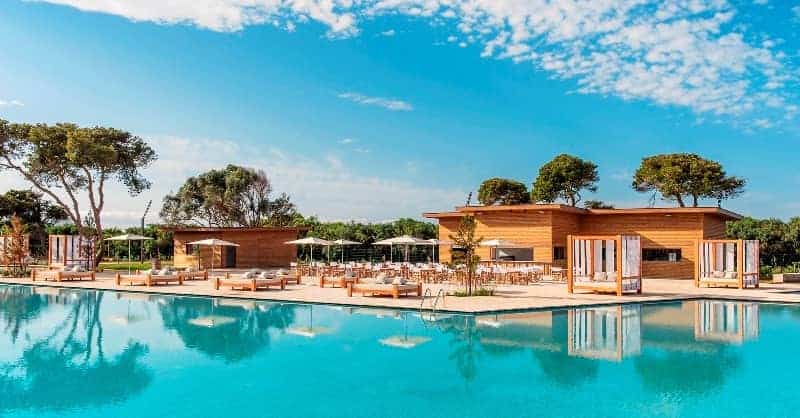 Luxury Moroccan hotel pool with outdoor seating and scenic landscape.