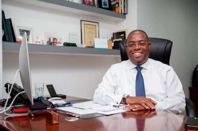 Businessman at Angola’s Oil, Gas, and Technology Conference, promoting energy innovation.