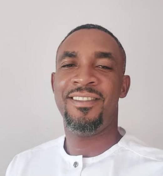 African man smiling while engaging with digital government services in Nigeria.