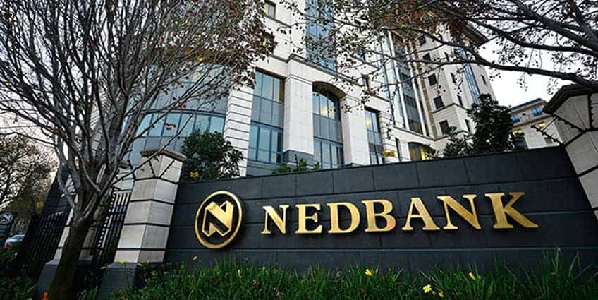 Nedbank office building with prominent logo in a modern urban setting.