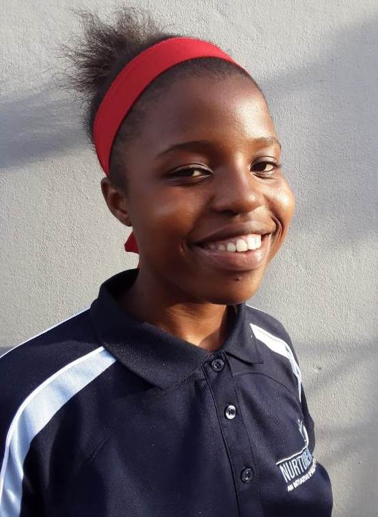 Young African girl with a bright smile, wearing a sports uniform and red headband, symbolizing achie.