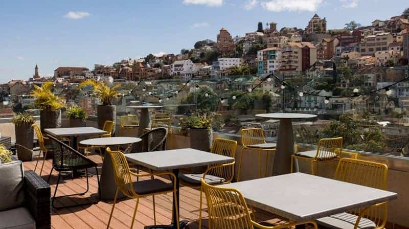 Rooftop terrace with outdoor seating and city view in Antananarivo, Madagascar, near Radisson Hotel.