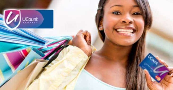 Smiling woman holding a UCount card and shopping bags, promoting savings and consumer spending.