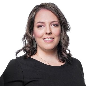 Woman smiling in professional attire, discussing vaccination policies at work.