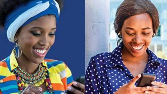 Two women using mobile phones for financial transactions in Africa.