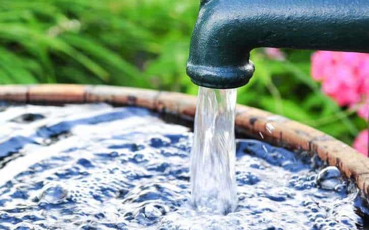 Water flowing from tap into basin, highlighting water conservation initiatives in Africa.