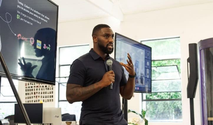 Zuberi speaking at fintech event in South Africa, representing Ghana.