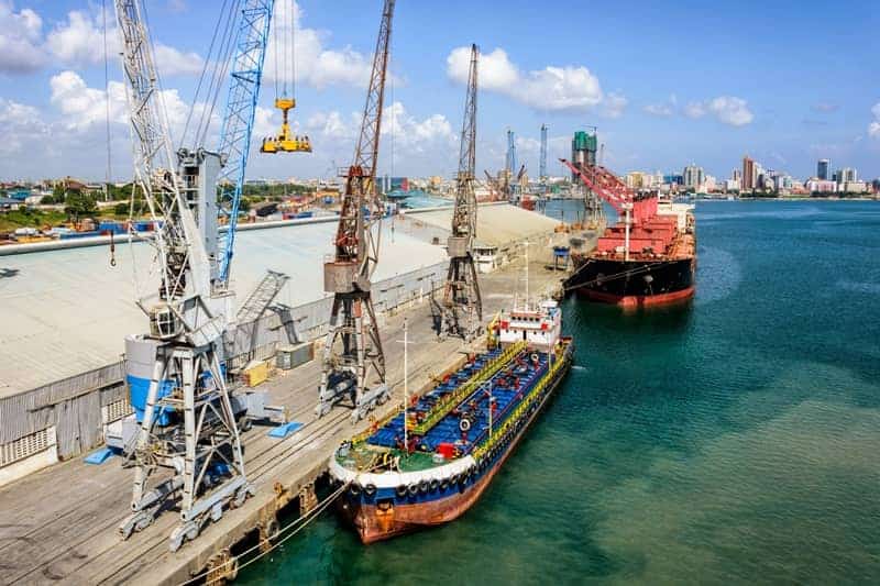 Port cranes and cargo ships facilitate Africa's trade expansion.