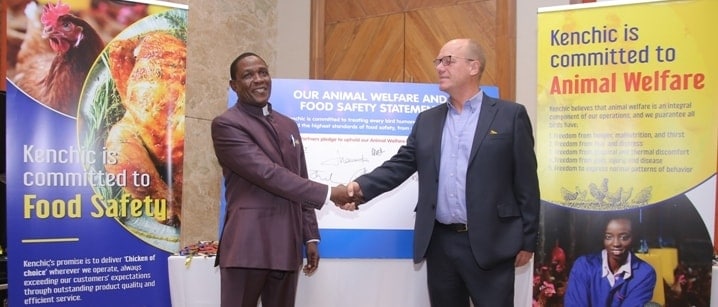 Two men shaking hands at Kenchic event promoting animal welfare and food safety initiatives.