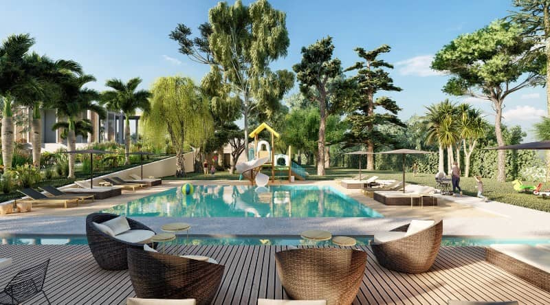 Elegant hotel pool area with lush greenery and lounge chairs in Africa.