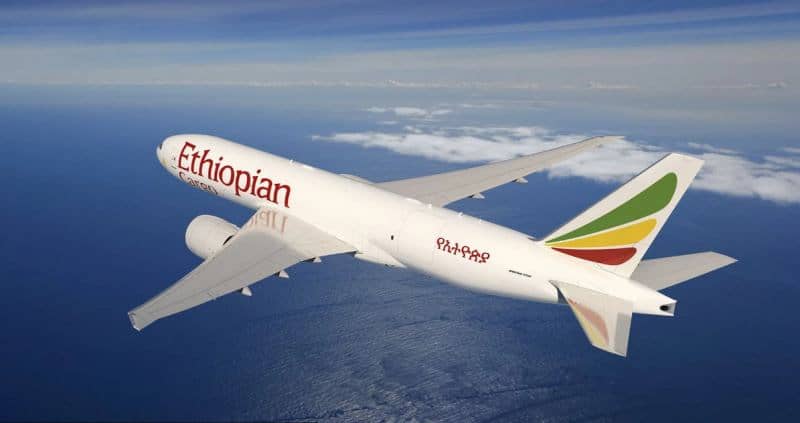 Ethiopian Airlines Boeing 777 freighter aircraft flying over the ocean.