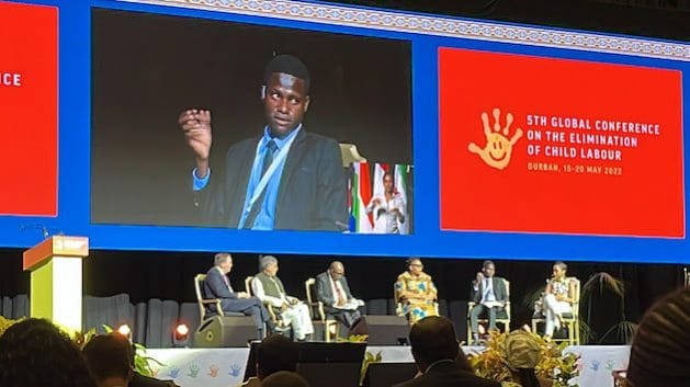 Activist speaking passionately at the global conference on child labour elimination.