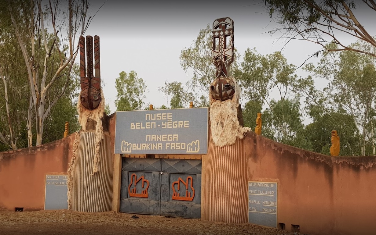 Traditional Burkina Faso entrance with tribal sculptures and symbols.