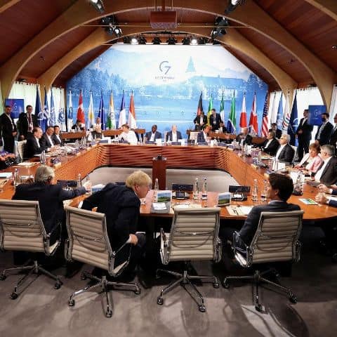 Business leaders at Africa conference discussing strategies in a modern meeting room.