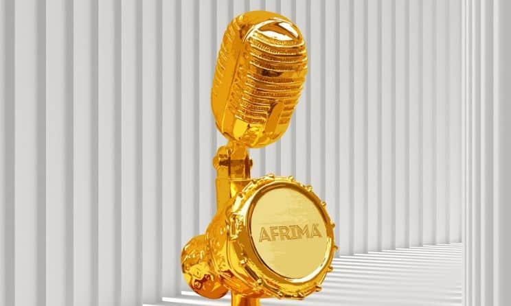 Gold microphone and AFRIMA award badge on striped background.