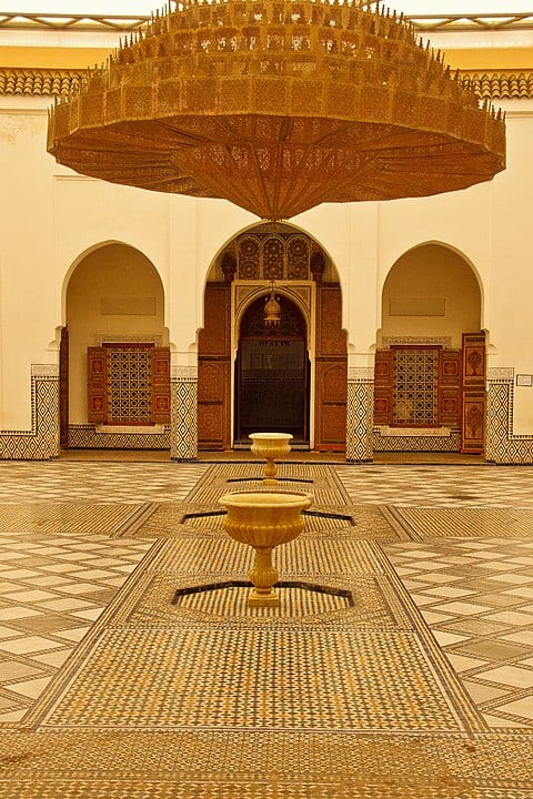 Traditional Moroccan courtyard with ornate architecture and central fountain.