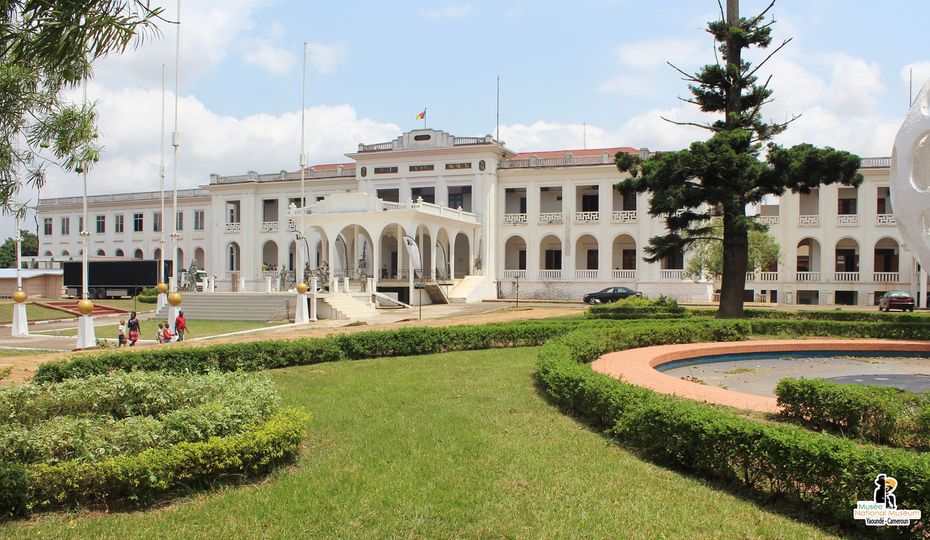 Historic Cameroon National Museum building with lush gardens and trees.