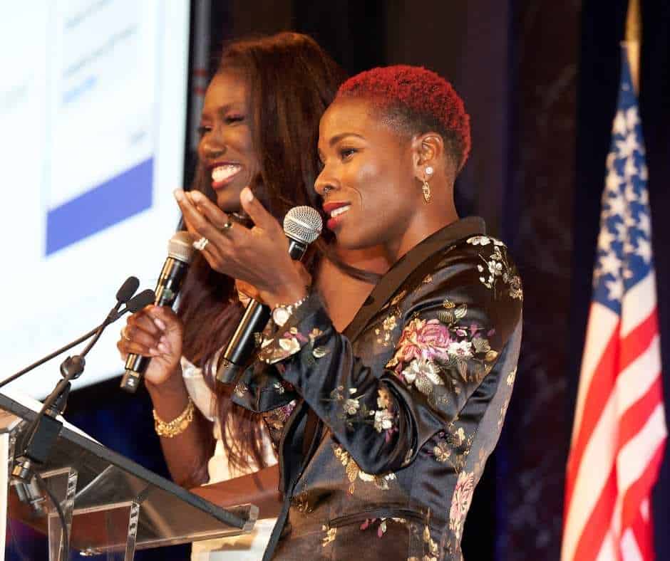 African women presenting at a professional event or seminar.