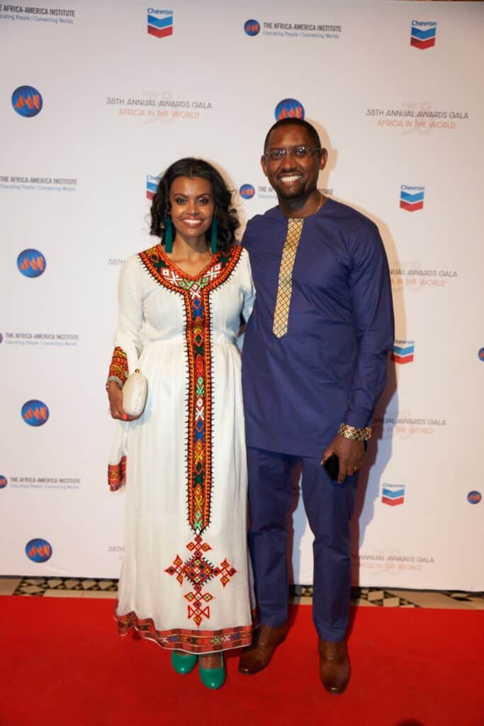 African couple at awards gala in traditional attire.