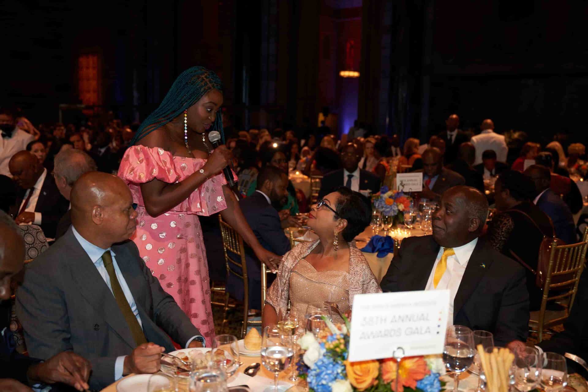 African women and men at a formal gala dinner, showcasing cultural diversity and success in Africa.