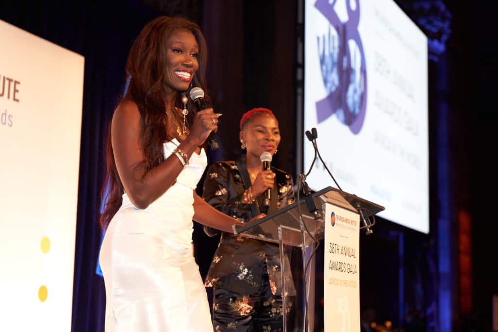 Vibrant African women speaking at a global conference.
