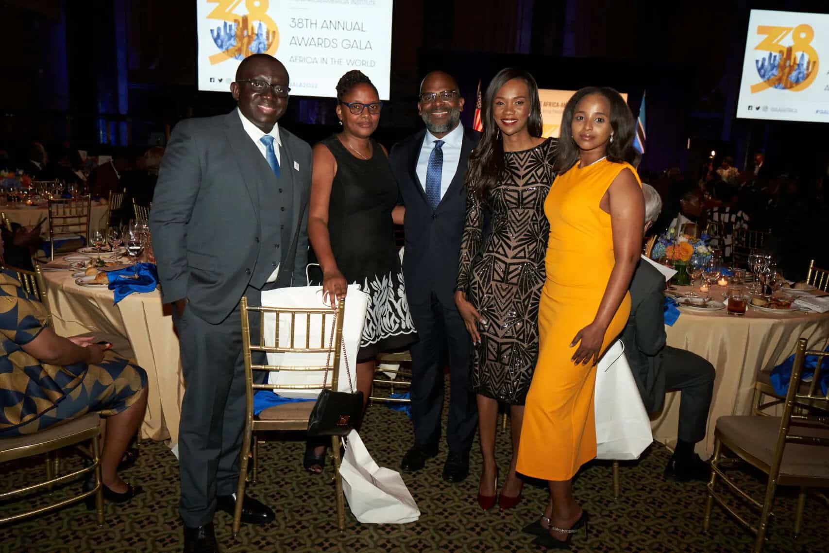 African professionals at formal event in elegant attire.