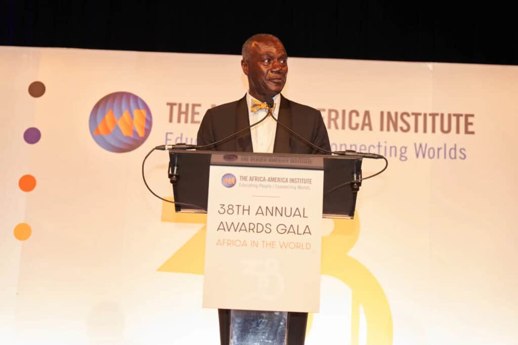 Distinguished man speaking at Africa Institute awards event.