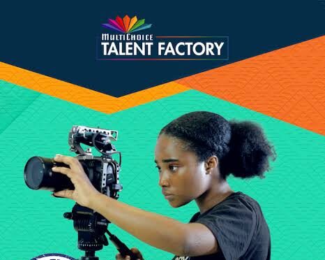 Young African girl operating a professional camera for media production.