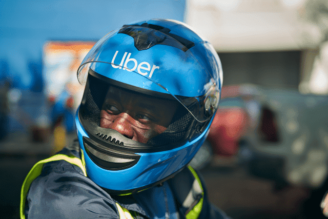 Uber driver wearing a blue helmet with safety features in Nigeria.