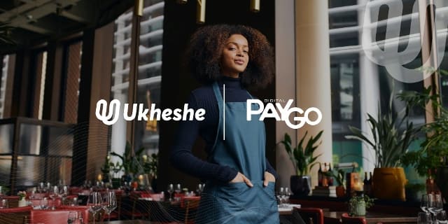 Woman using digital payment solutions in a modern restaurant setting.