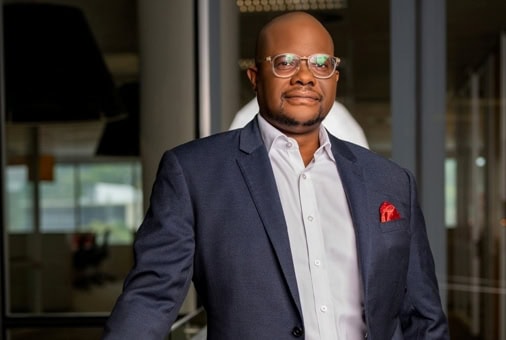 Ghanaian business leader in formal attire, representing growth and innovation in Ghana's corporate s.