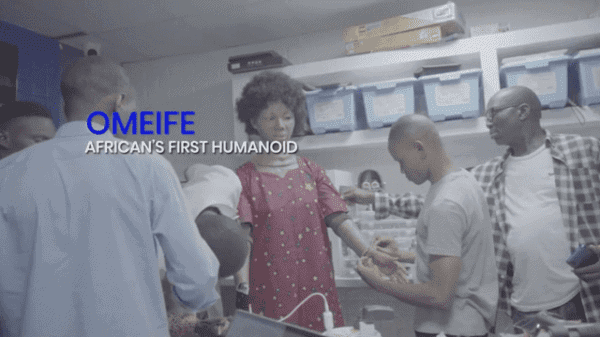 Africa’s first humanoid robot Omeife showcased with people in a lab setting.