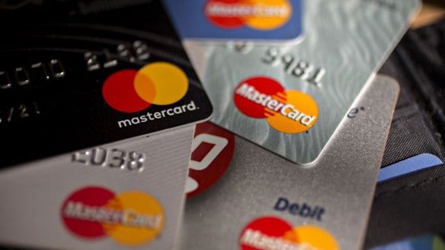 Close-up of Bank One premium Mastercard credit cards on a table.