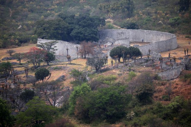 Ancient Zimbabwe ruins surrounded by lush greenery at the Great Zimbabwe World Heritage Site.