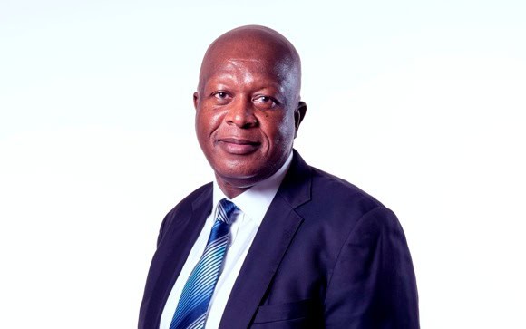 African financial expert in formal suit promoting market development.