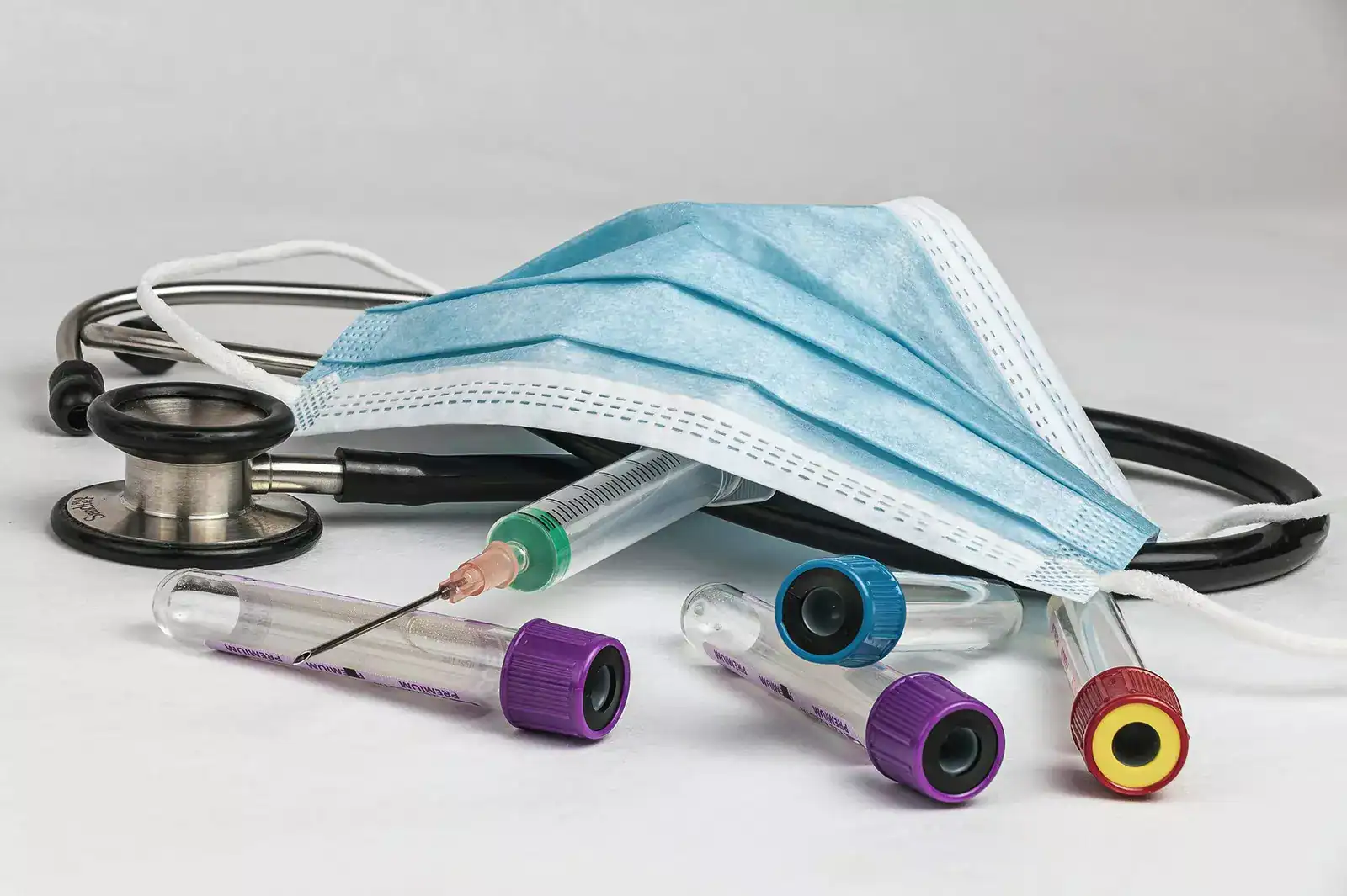 Personal protective equipment including face masks and syringes for medical use.