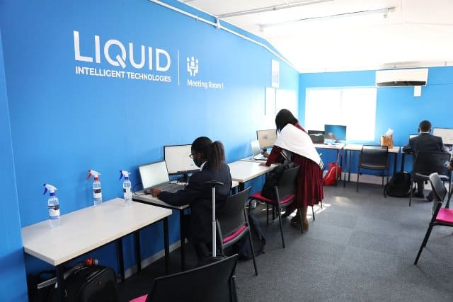 African tech hub with professionals working on computers in a modern office.