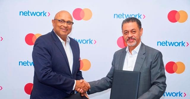 Mastercard and Network International shake hands at AI fraud prevention launch.