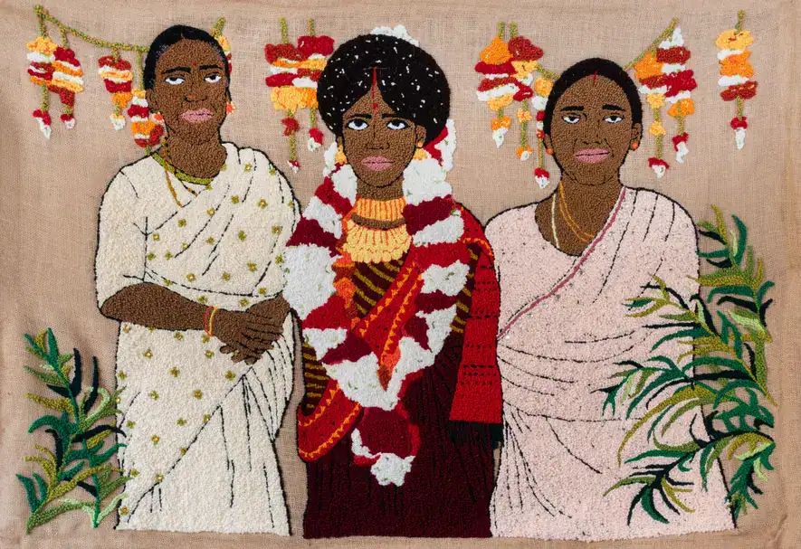 Three women in traditional African attire at the Cape Town Art Fair.