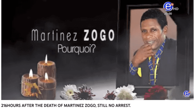 Memorial tribute to Martinez Zogo with candles and flowers.