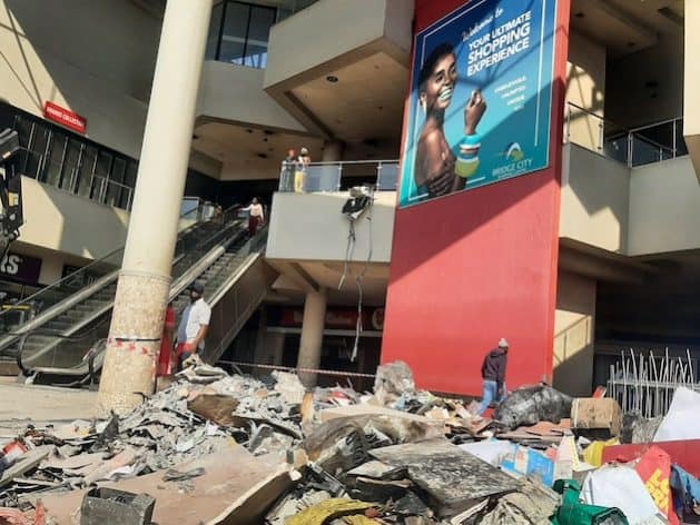 Debris and damage at a shopping mall amid economic challenges in South Africa.