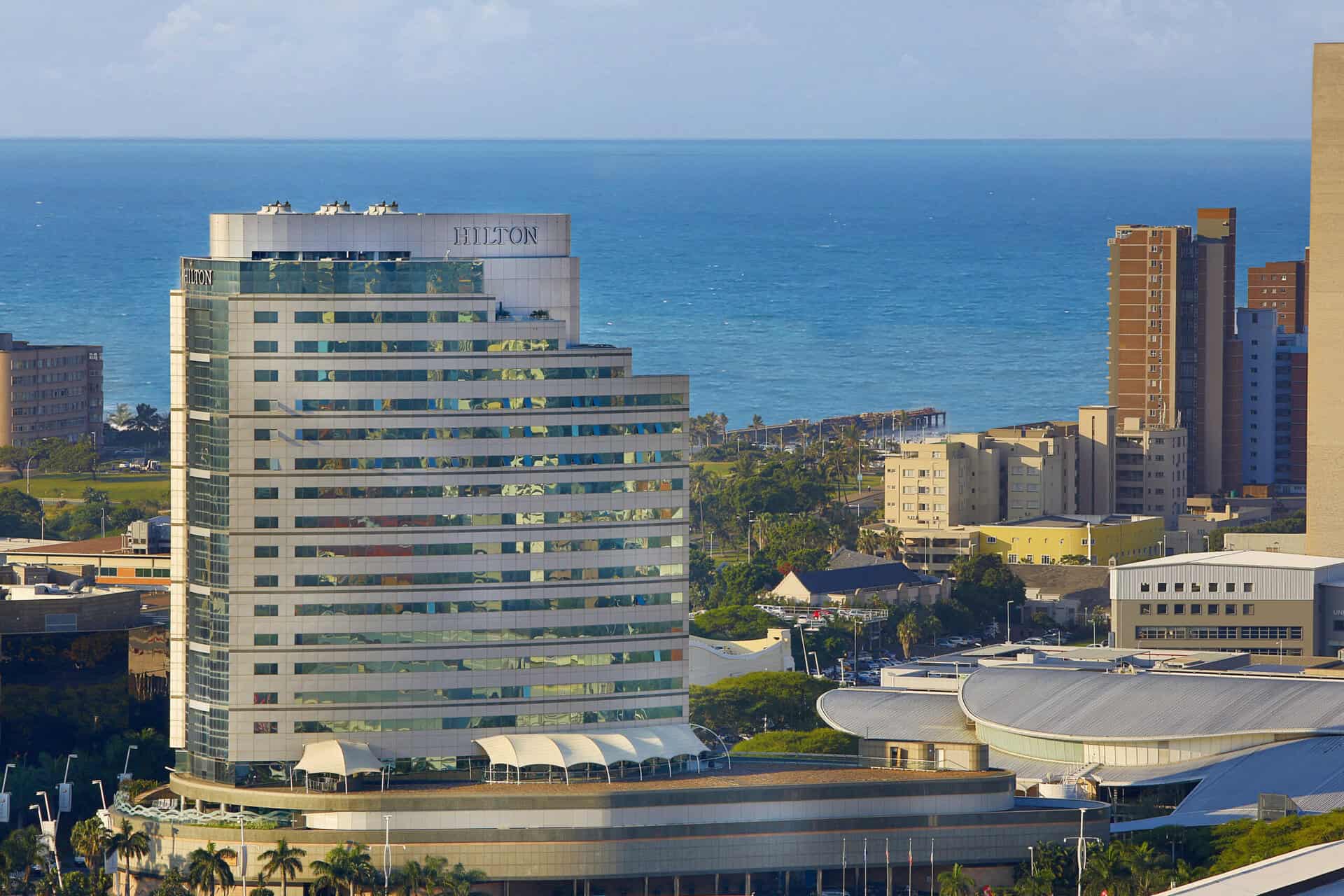 Hilton hotel overlooking the ocean, showcasing sustainable hospitality in Africa.