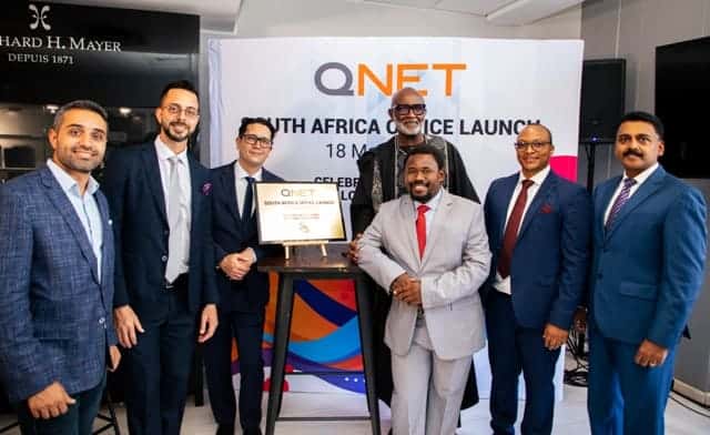 QNET team celebrating South Africa office launch for business growth.
