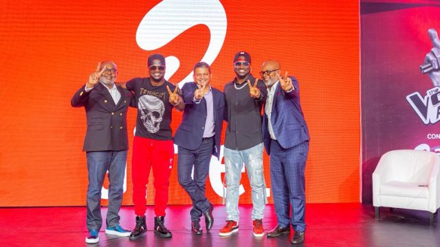 Group of diverse men on stage at Africa's Voice TV launch event showcasing African talent and entert.