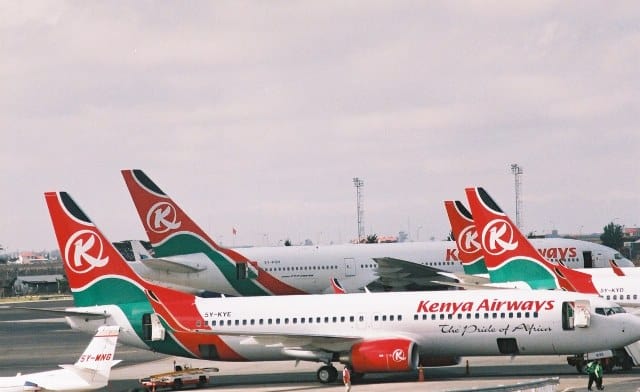 Kenya Airways airplanes parked on the tarmac, ready for flight operations.