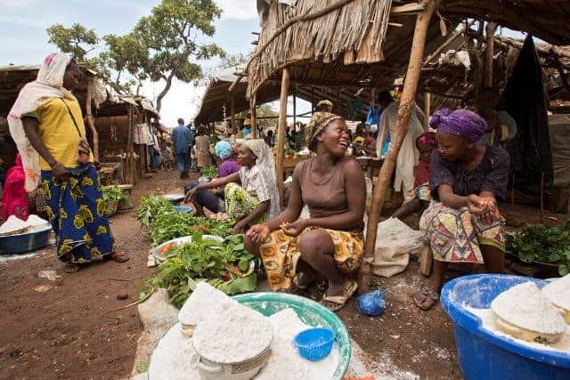 Women selling fortified flour and fresh produce at a local Kenyan market.