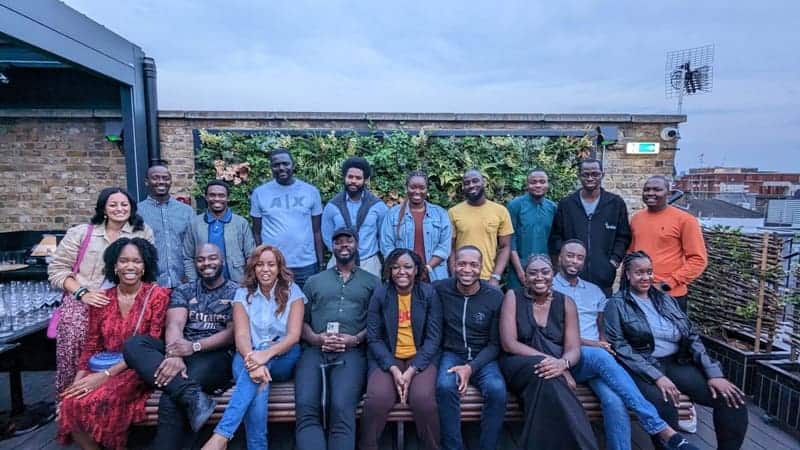 African entrepreneurs posing together on a rooftop in celebration of startup success.